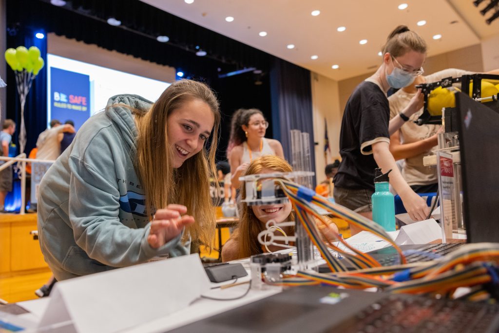 Students look at projects at MakerFest